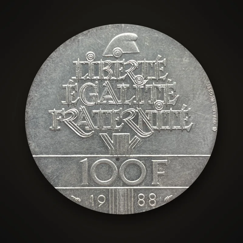 100 francs argent Fraternité 1988, revers : devise sous un bonnet phrygien, valeur 100 F